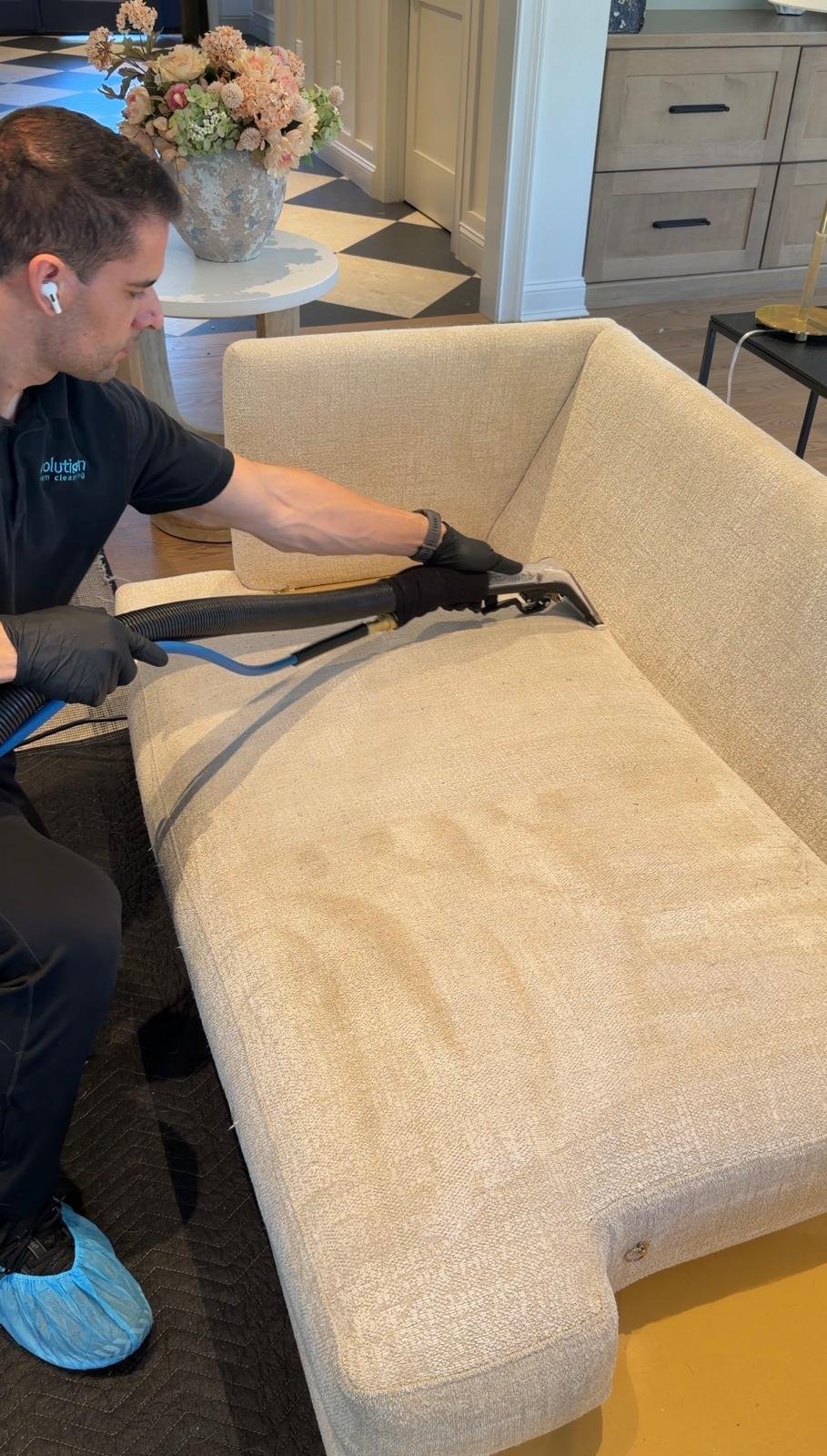 Alex steam cleaning a light fabric sectional sofa